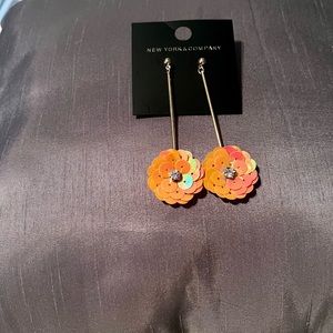 A pair of coral color earrings